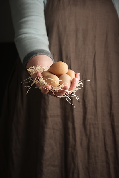 Woman holding guinea fowl eggs in hand Rustic style