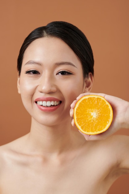 Woman Holding Half of Orange