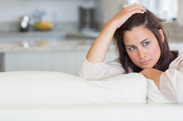 Woman holding hand on head