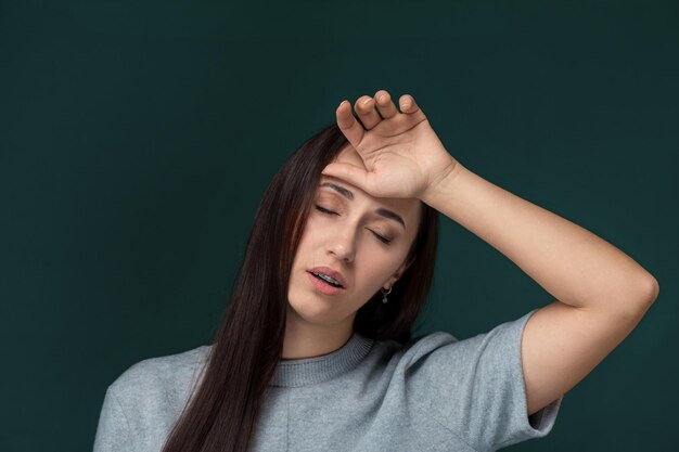 Woman holding her head in her hands