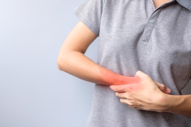 Woman holding her wrist pain because using smartphone or computer long time De Quervain s tenosynovitis Intersection Symptom Carpal Tunnel Syndrome or Office syndrome concept