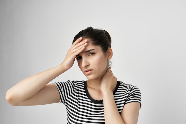 Woman holding his head migraine depression light\
background