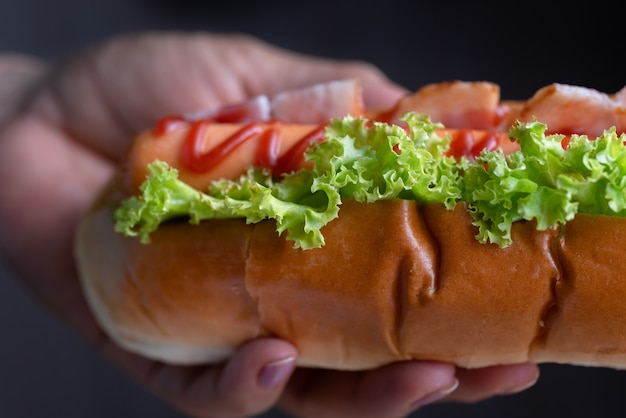 Woman holding hot dog