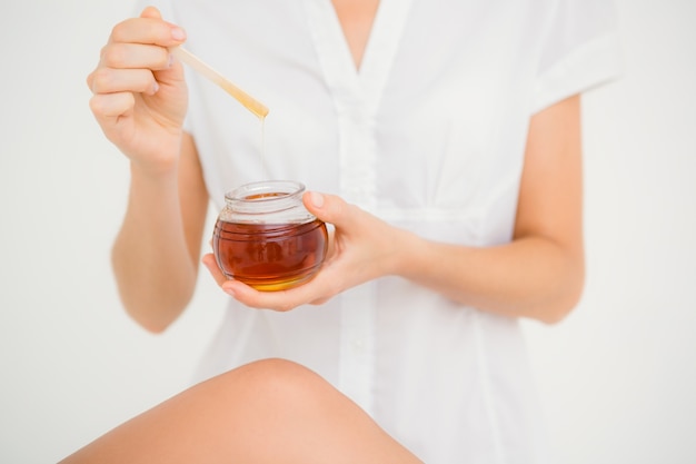 Woman holding hot wax in bowl