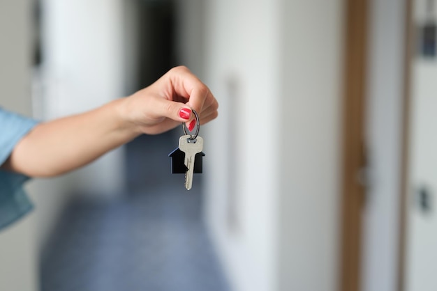 Woman holding house keys hands closeup