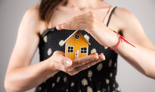 Woman holding a house model