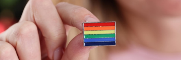 Woman holding icon with lgbt flag in her hands closeup lgbt rights concept