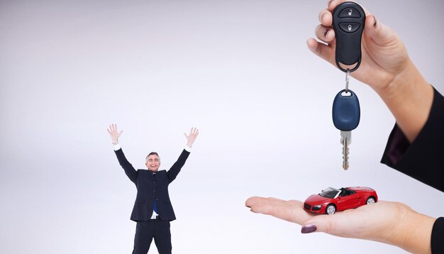 Photo woman holding key and small car against grey background