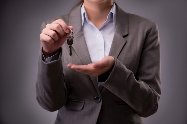 Woman holding keys in housing mortgage 