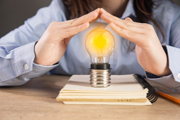 Woman holding light bulb