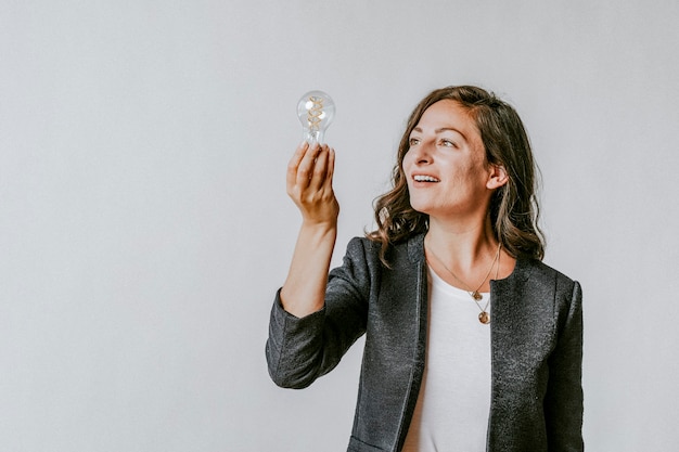 Woman holding a light bulb