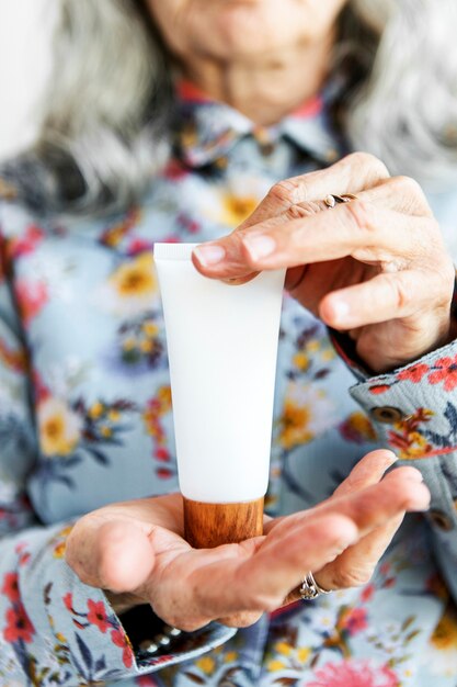 Woman holding lotion with both hands