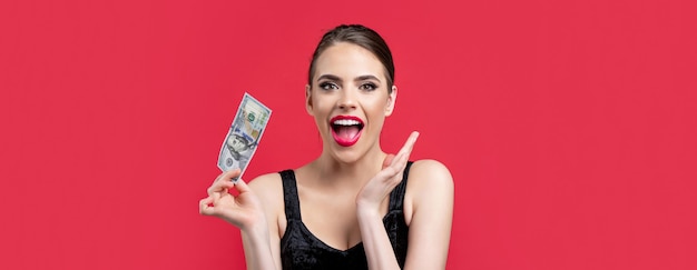 Woman holding lots of money in dollar currency. Luxury, beauty and money concept. Woman with dollars in hand. Portrait woman holding money banknotes