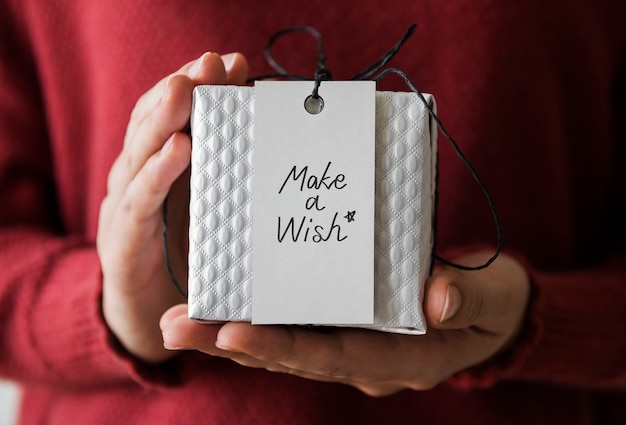 Woman holding a Make a Wish present