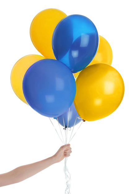Woman holding many balloons in colors of Ukrainian flag on white background closeup
