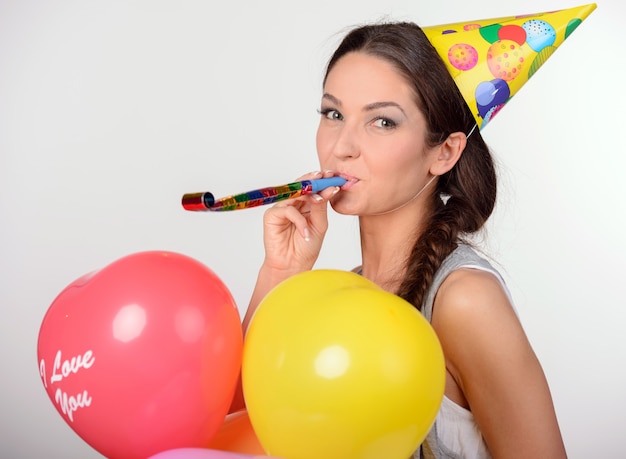 Woman holding many balloons in heart-shaped.