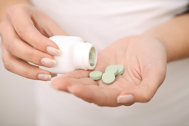 Woman holding medicines in her hands