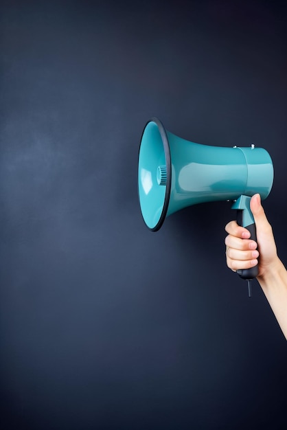 Woman holding a megaphone on a blue background with copy space Generative AI