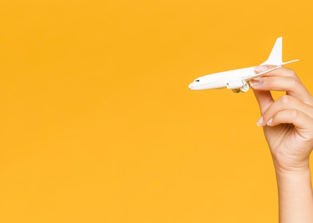 Woman holding a miniature plane