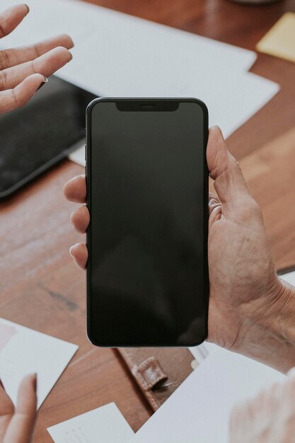 Woman holding a mobile phone screen