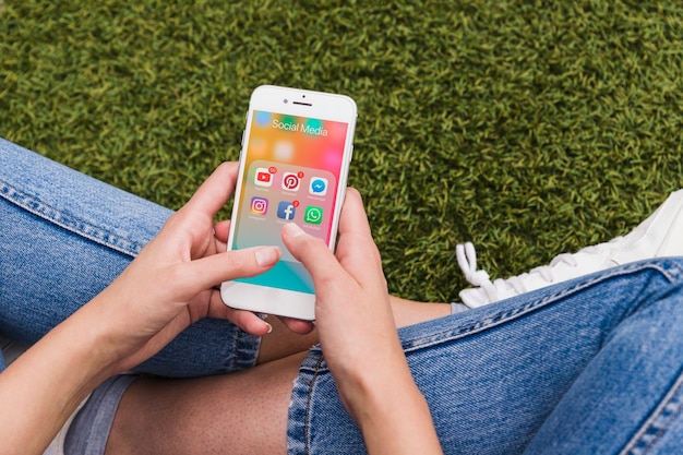 Photo woman holding mobile using social network applications