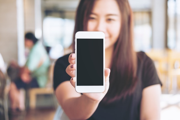 Woman holding mockup phone