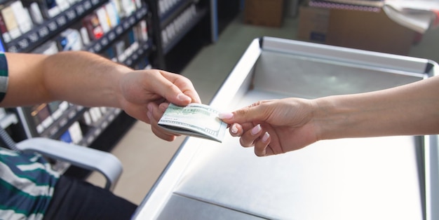 Woman holding money at supermarket