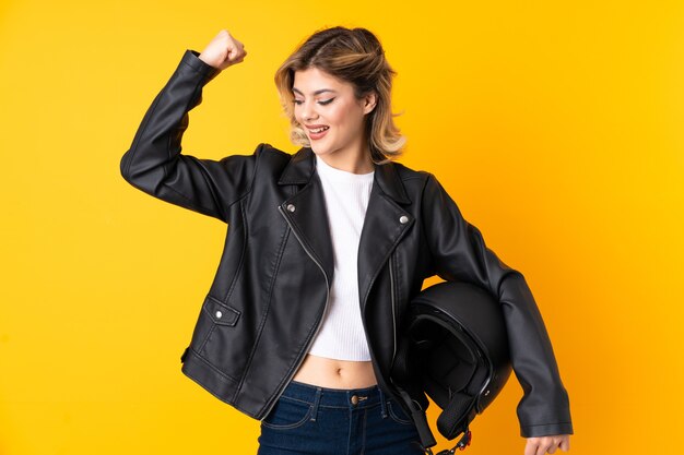 woman holding a motorcycle helmet celebrating a victory