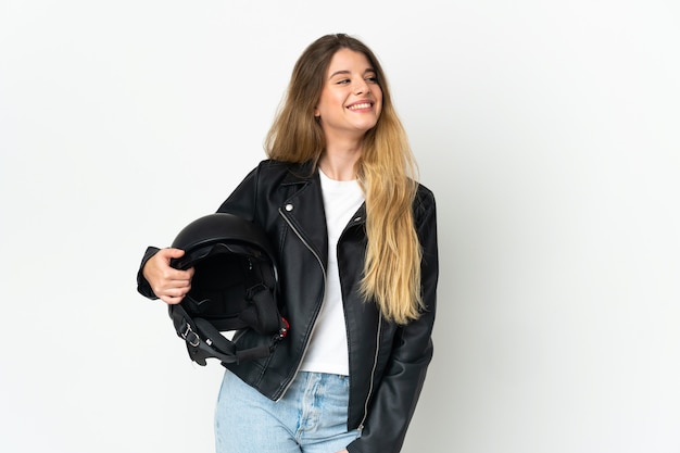 Photo woman holding a motorcycle helmet isolated thinking an idea while looking up