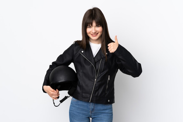 Woman holding a motorcycle helmet isolated on white giving a thumbs up gesture