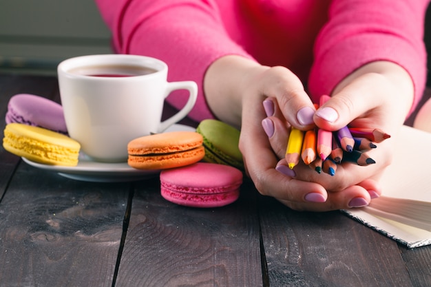 Woman holding a multicolored pencils