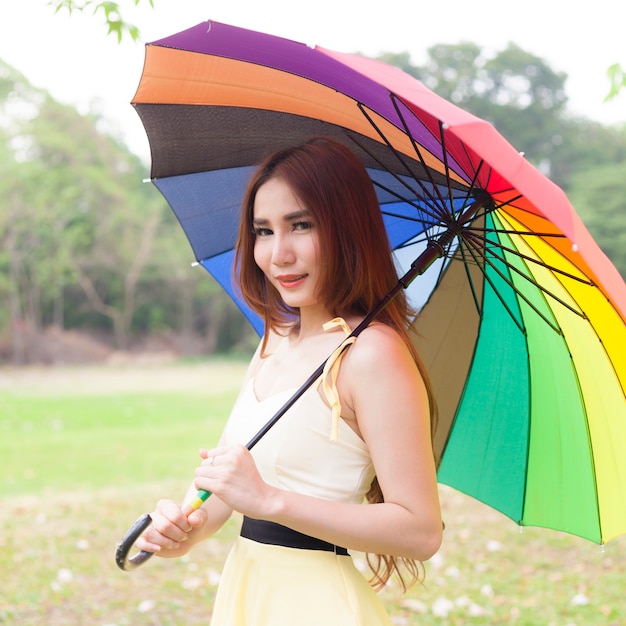 Woman holding multicolored umbrella