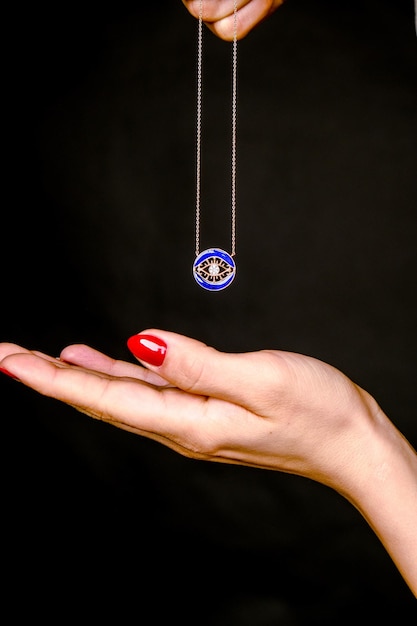 a woman holding a necklace that says  starbucks  on it