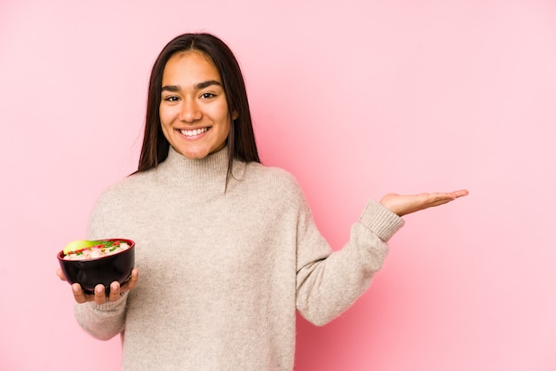 Woman holding a noodles soup bowl