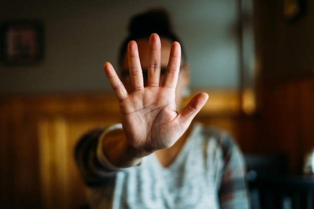 Woman holding out hand indicating stop