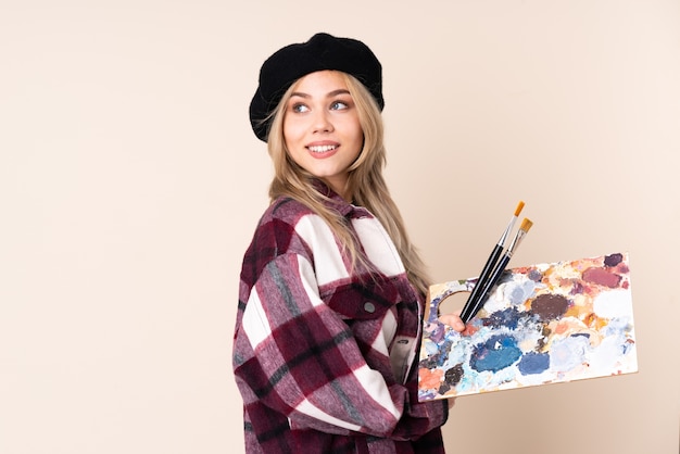 Woman holding a palette in studio