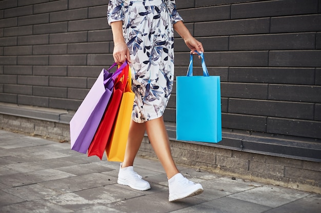 Woman holding paper bags walking on the street