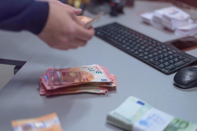 Woman holding paper currency over table