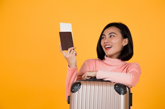 Woman holding a passport with an airplane ticket