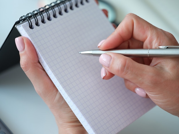 Woman holding pen and notebook