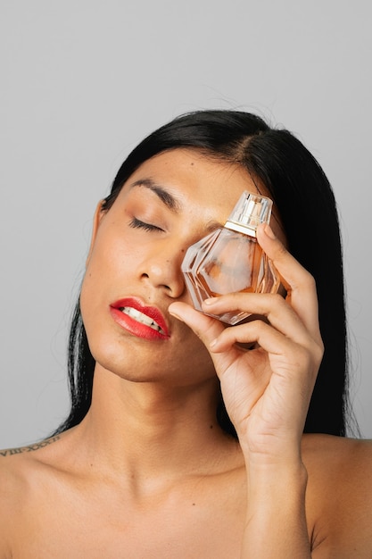 Woman holding a perfume glass bottle