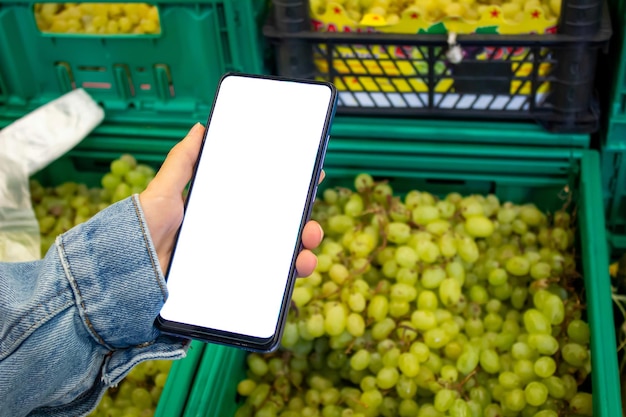 Woman holding phone with blank white mockup screen