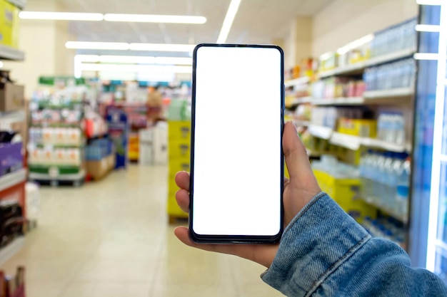 Woman holding phone with blank white mockup screen
