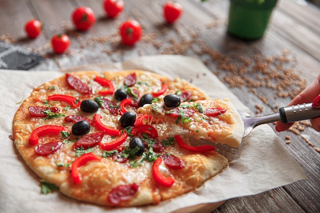 Woman holding piece of pizza