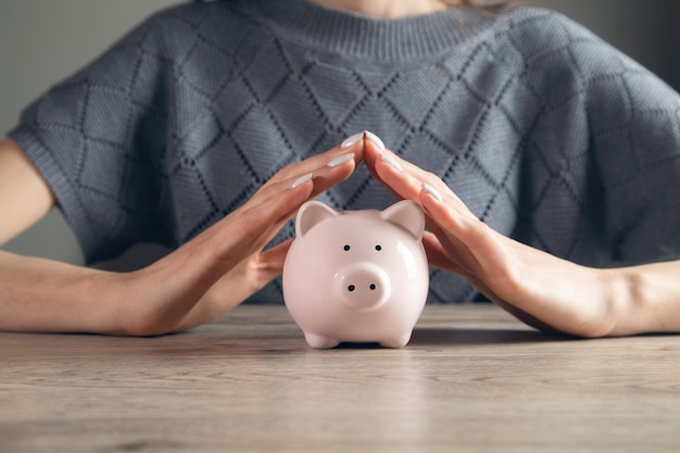 Woman holding piggy bank Saving money concept