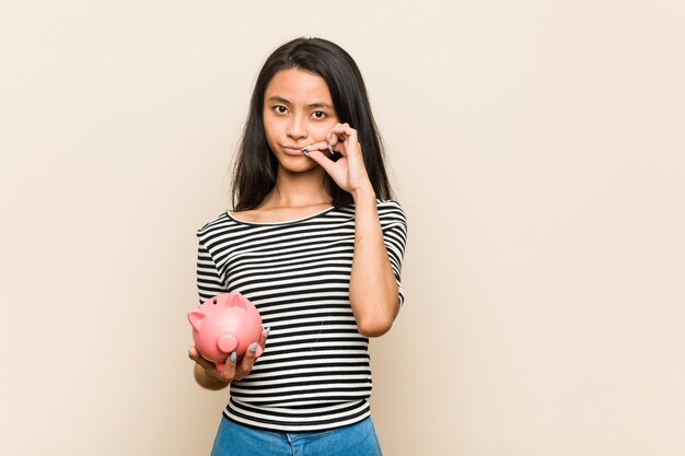 Woman holding a piggy bank