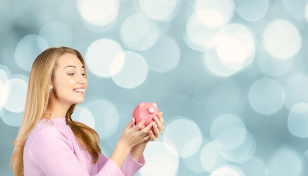 Woman Holding a Piggy Bank