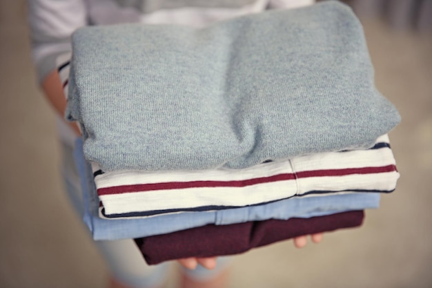 Woman holding pile of clothes closeup