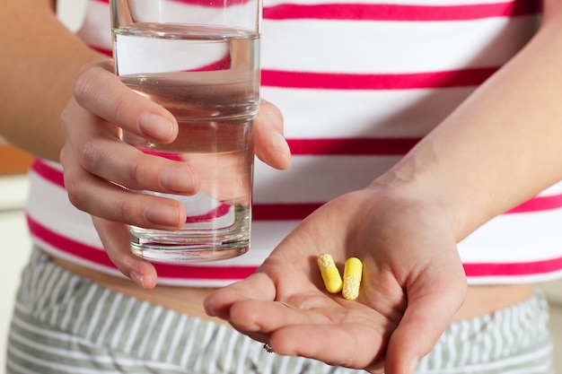 Woman holding pills in her hands