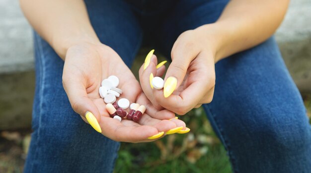 Woman holding pills in outdoor